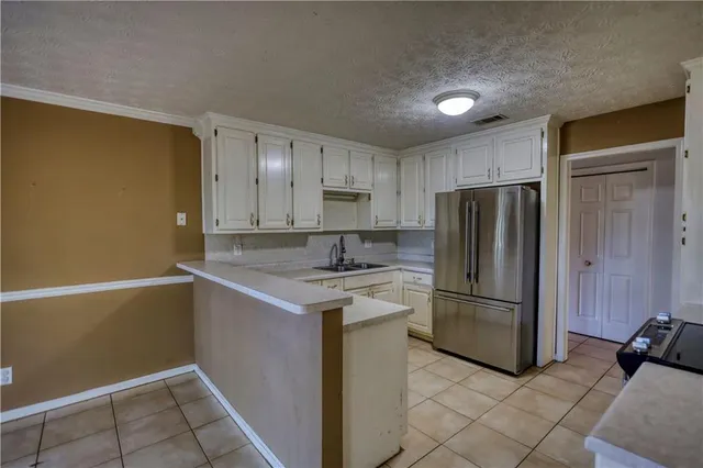 a kitchen with stainless steel appliances granite countertop white cabinets sink and dishwasher