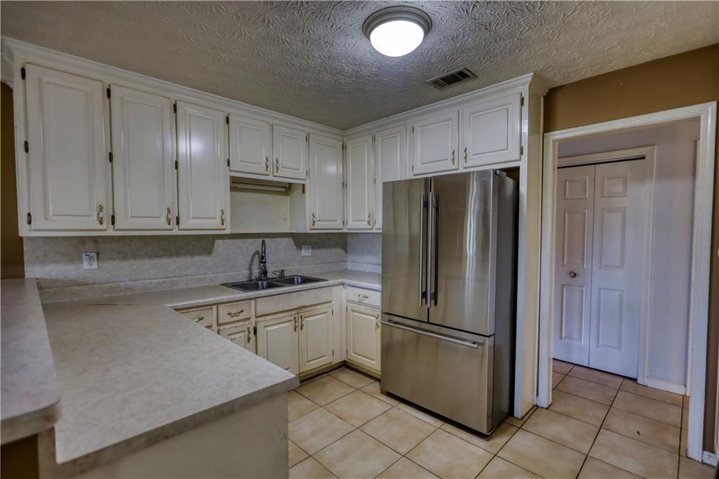 55 Ashland Farm Road Oxford, GA 30054 - Photo 20 of 55 a kitchen with stainless steel appliances granite countertop a refrigerator sink and cabinets