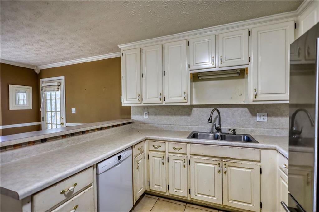 55 Ashland Farm Road Oxford, GA 30054 - Photo 21 of 55 a kitchen with stainless steel appliances granite countertop white cabinets sink and dishwasher