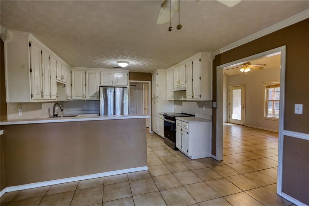 55 Ashland Farm Road Oxford, GA 30054 - Photo 27 of 55 a kitchen with stainless steel appliances granite countertop a refrigerator a sink a stove and white cabinets