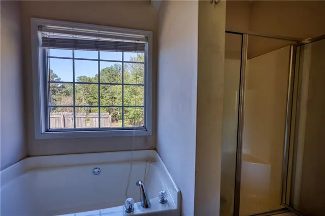 a white toilet sitting next to a bathroom sink and a shower
