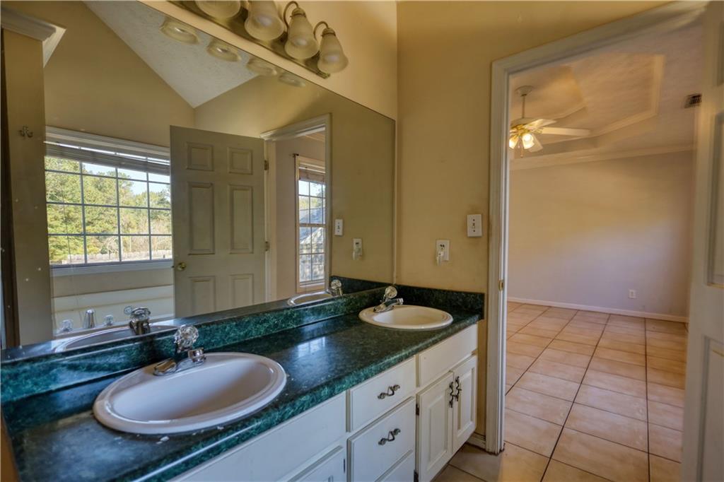 55 Ashland Farm Road Oxford, GA 30054 - Photo 36 of 55 a bathroom with a granite countertop sink a mirror and a shower
