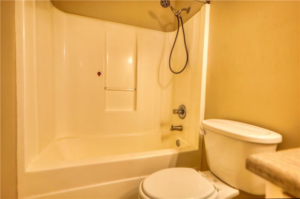 55 Ashland Farm Road Oxford, GA 30054 - Photo 38 of 55 a white toilet sitting next to a bathroom sink and a shower