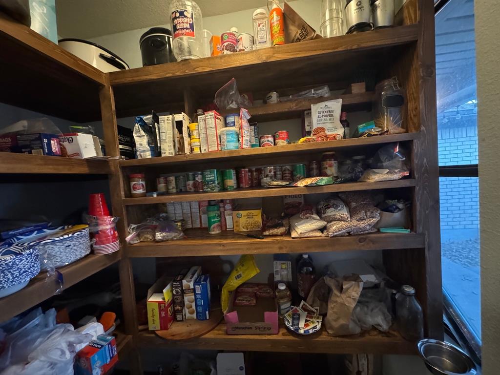 817 South Bell Street Hamilton, TX 76531 - Photo 13 of 28 a store room with lots of different colored cloths