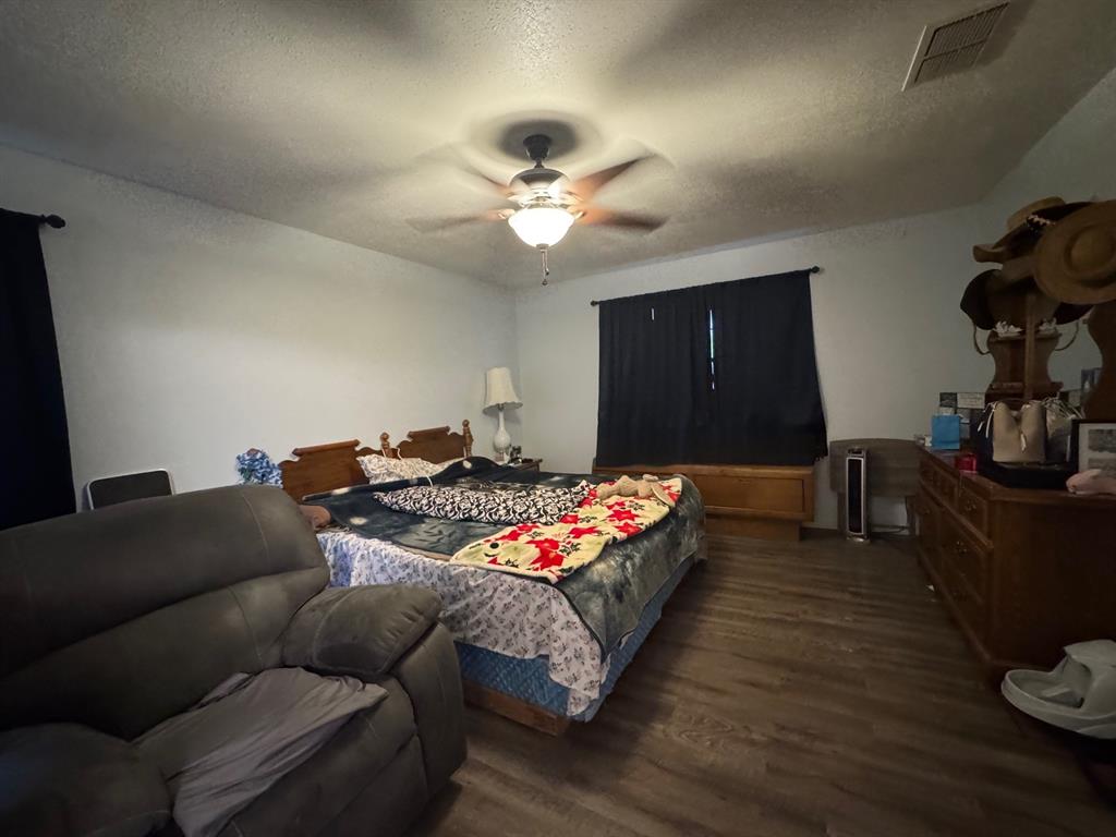 817 South Bell Street Hamilton, TX 76531 - Photo 15 of 28 a living room with furniture and a flat screen tv