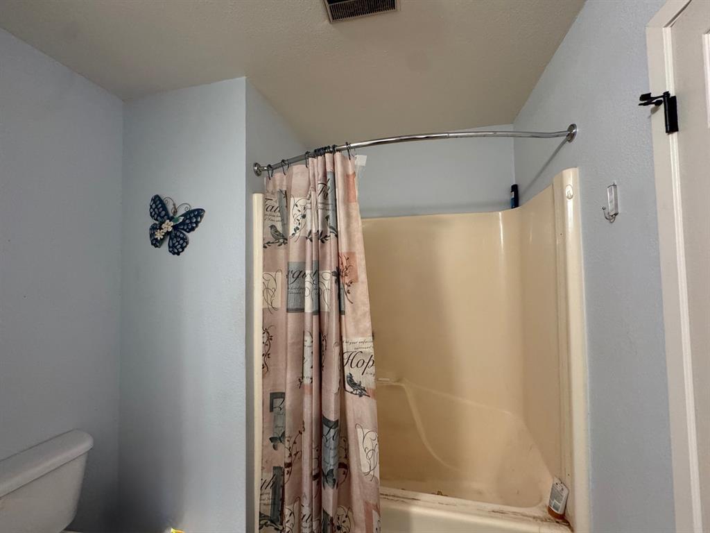 817 South Bell Street Hamilton, TX 76531 - Photo 22 of 28 a bathroom with a shower and a toilet