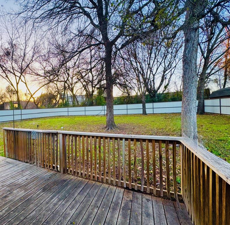 817 South Bell Street Hamilton, TX 76531 - Photo 25 of 28 a view of wooden deck with a trees and wooden fence