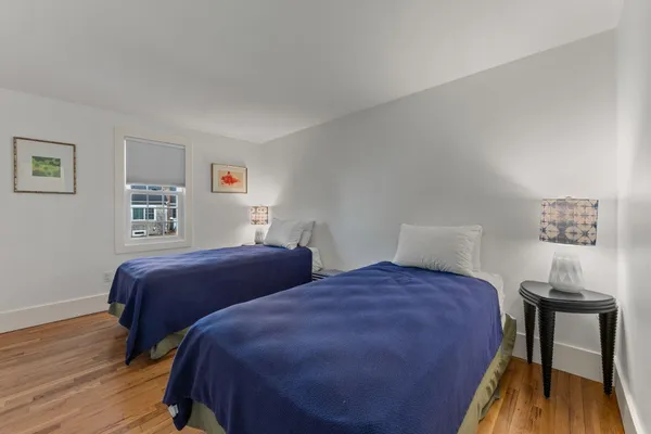 a bedroom with two beds and a desk