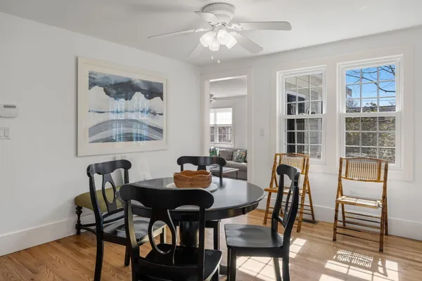 a view of a dining room with furniture window and wooden floor