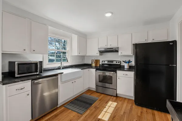 a kitchen with a refrigerator stove and microwave