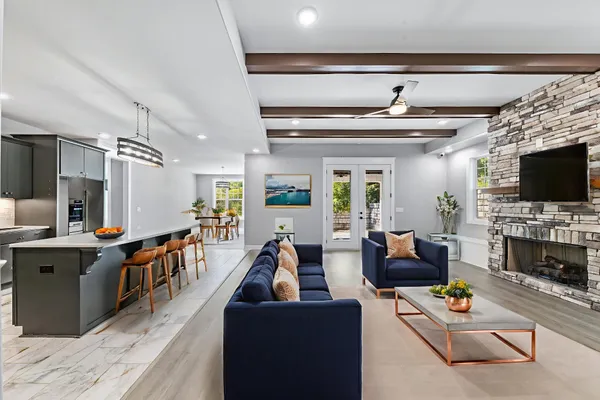 a large kitchen with stainless steel appliances a large counter top a stove and a sink