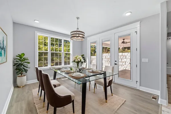 a bathroom with a sink a light fixture and a mirror