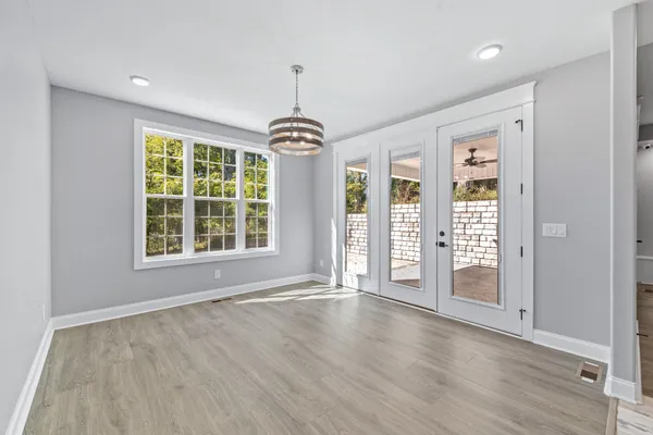 a bathroom with a double vanity sink toilet mirror and shower