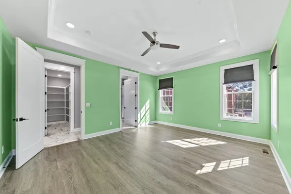 a view of a hallway with wooden floor and a fireplace
