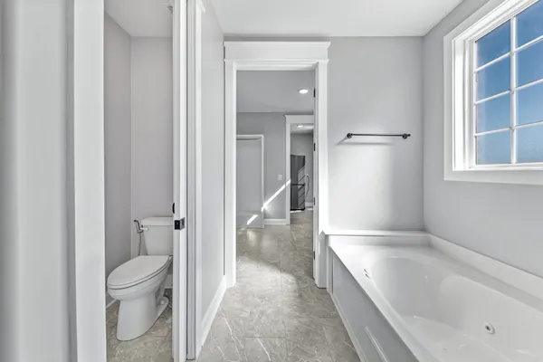 a view of a livingroom with wooden floor and a ceiling fan