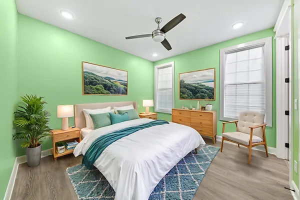 a view of an empty room with a ceiling fan and a floor to ceiling window