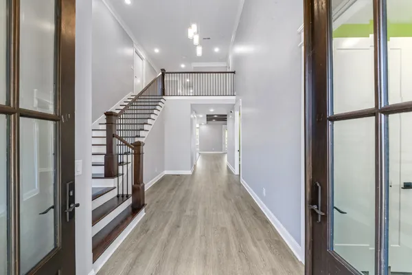 a view of empty room with wooden floor and fireplace
