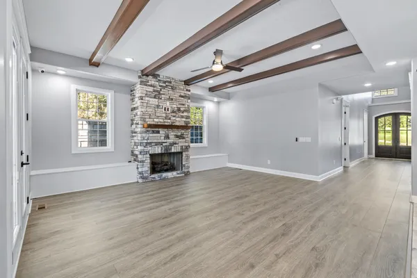 a living room with a fireplace and a floor to ceiling window