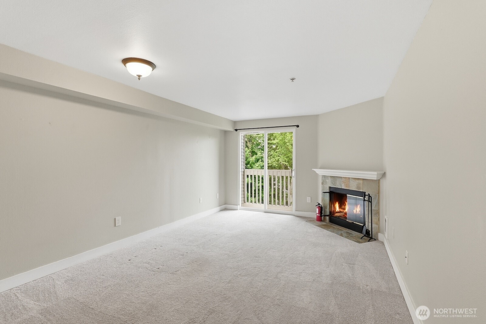 16409 Currie Road Southeast, Unit A308 Monroe, WA 98272 - Photo 5 of 21 a view of an empty room with a fireplace and a window