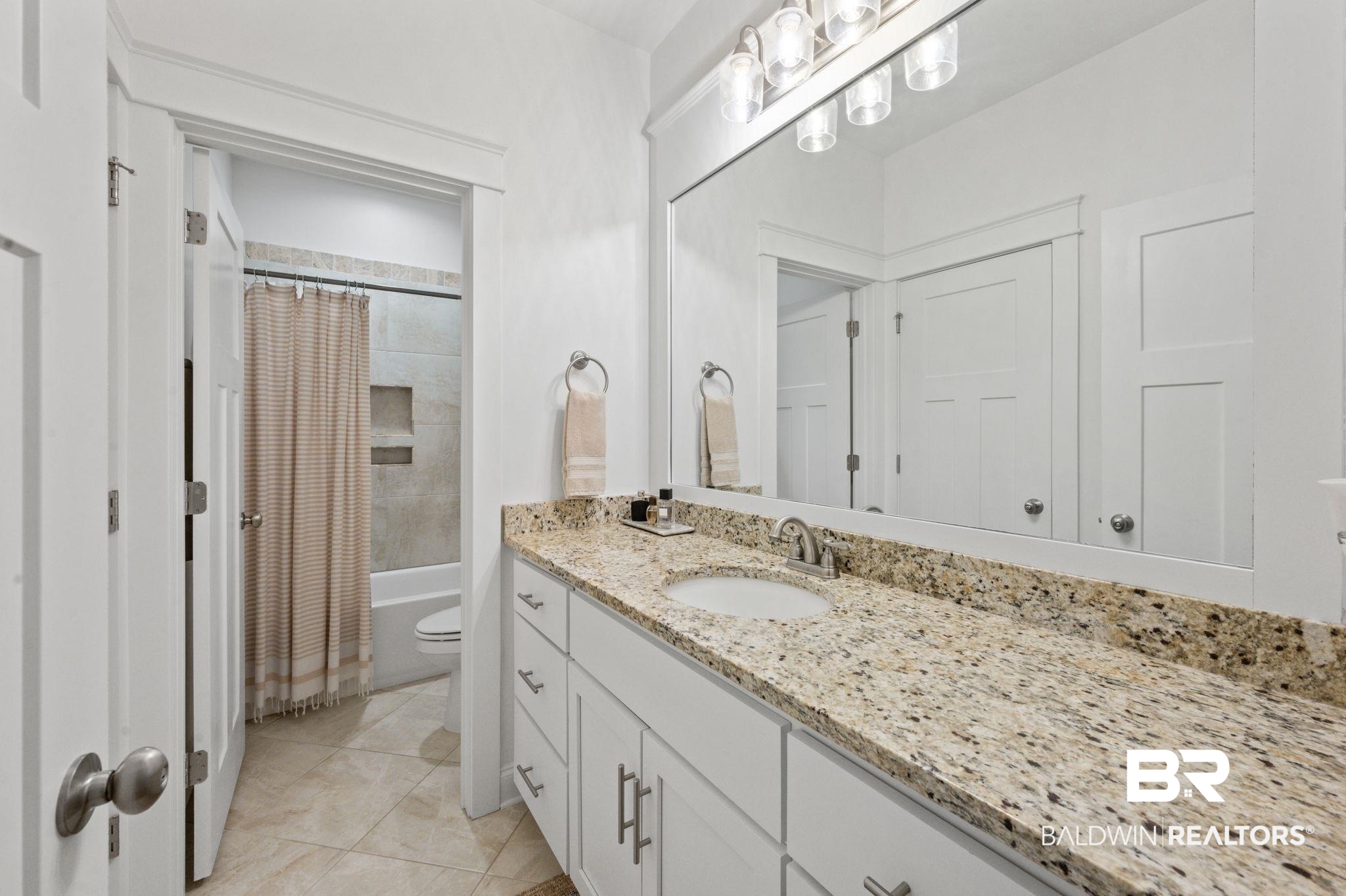 418 Fortune Drive Fairhope, AL 36532 - Photo 39 of 63 Full bathroom featuring vanity, shower / tub combo with curtain, toilet, and tile patterned floors