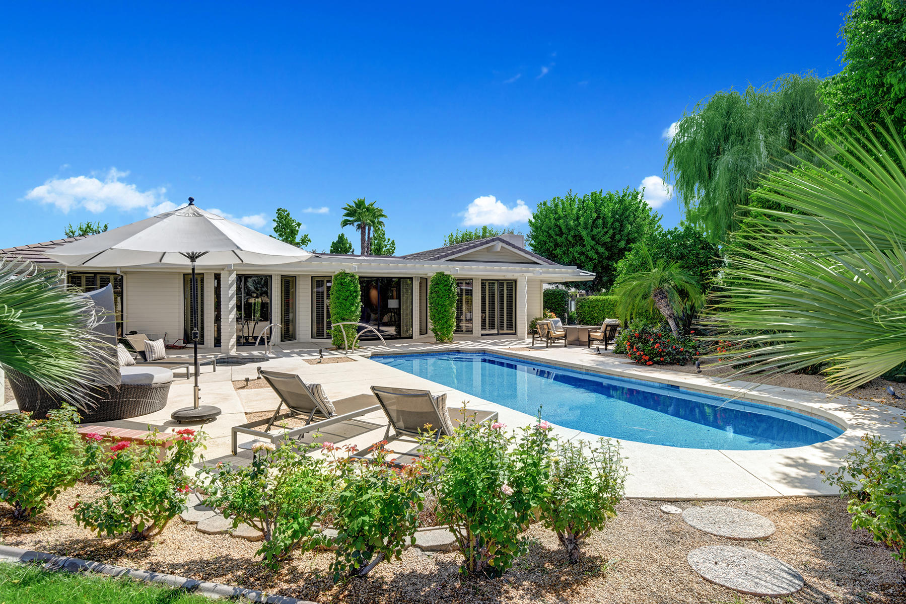 6 Eaton Rancho Mirage, CA 92270 - Photo 1 of 36 a view of house with swimming pool outdoor seating and house in the background