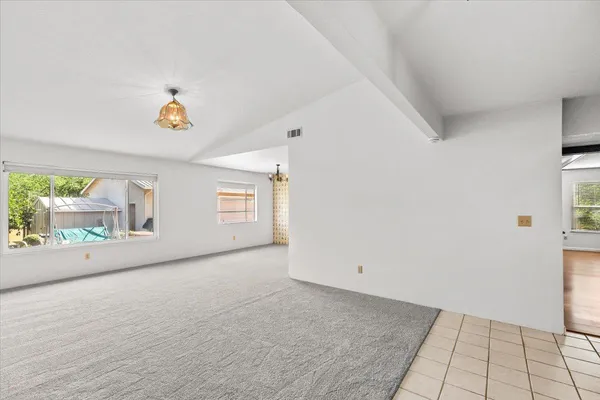 a kitchen with stainless steel appliances granite countertop a sink a stove a refrigerator and cabinets