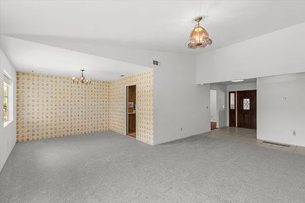 an empty room with windows and closet