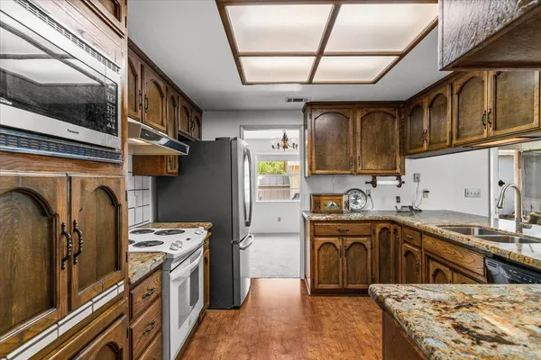 a view of a livingroom with a fireplace and windows