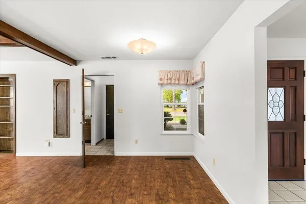 a kitchen with kitchen island granite countertop a sink a counter space and cabinets