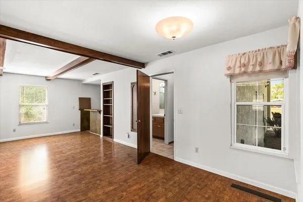 a view of a livingroom with wooden floor and closet