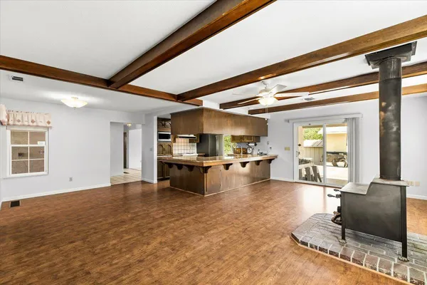 an empty room with a ceiling fan and a window