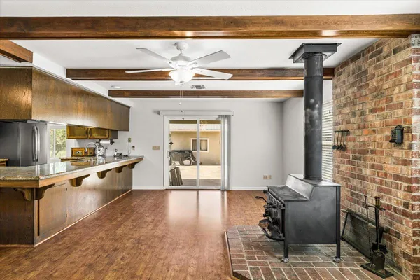 a view of a backyard with table and chairs potted plants and wooden fence