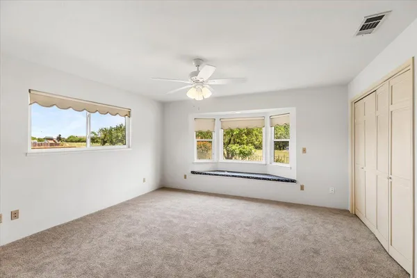 an aerial view of a residential houses with outdoor space and trees