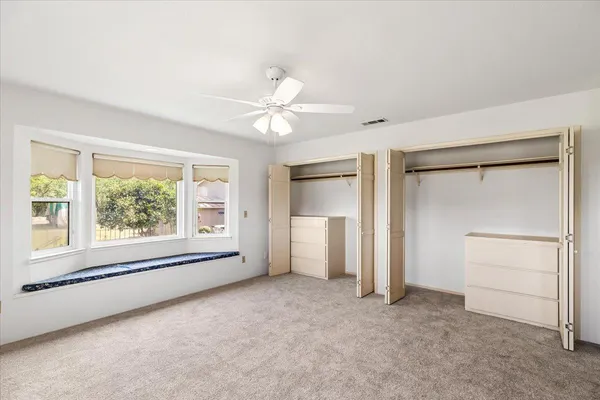 a view of a swimming pool and outdoor seating