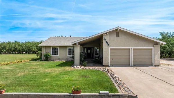 a front view of house with yard and outdoor seating