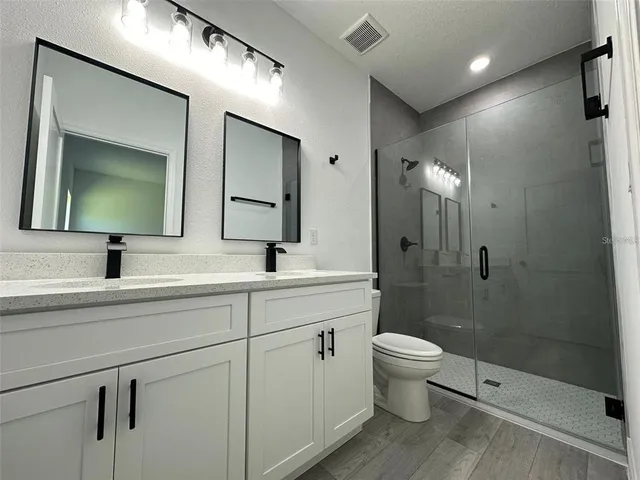 a bathroom with a toilet sink double and mirror