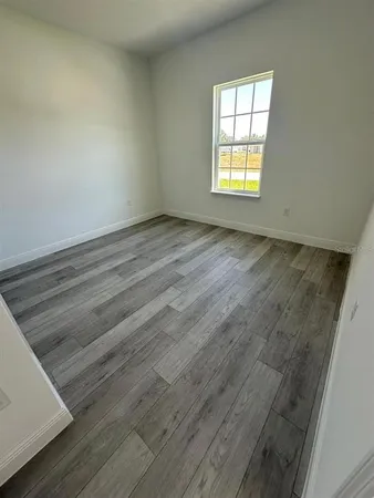 a view of a kitchen with furniture and wooden floor