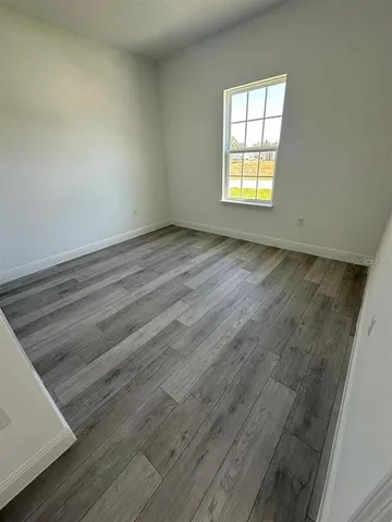 a view of a kitchen with furniture and wooden floor