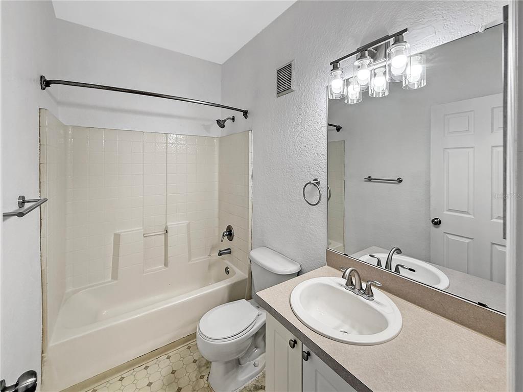 860 Grand Regency Pointe, Unit 200 Altamonte Springs, FL 32714 - Photo 13 of 23 a bathroom with a sink granite tub toilet and shower