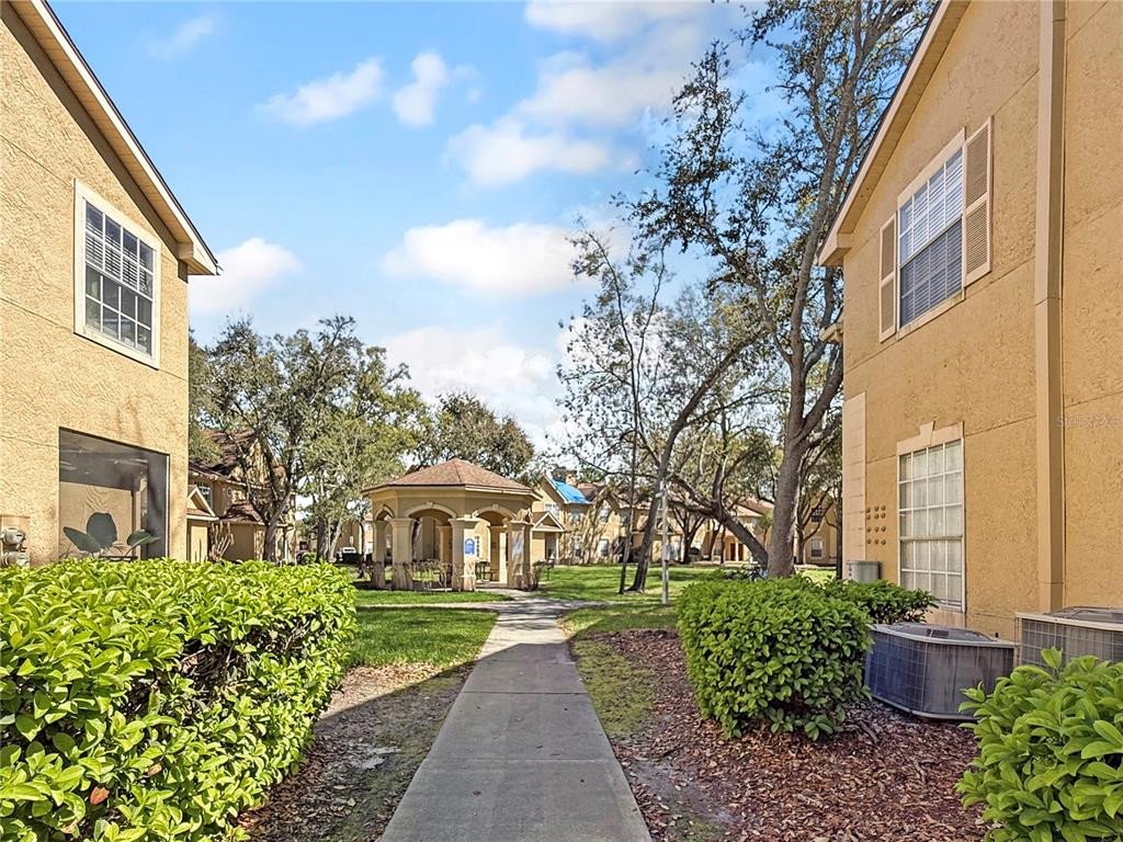 860 Grand Regency Pointe, Unit 200 Altamonte Springs, FL 32714 - Photo 19 of 23 a front view of a house with garden
