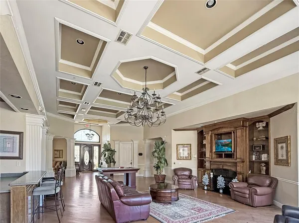 a living room with furniture a fireplace and a chandelier