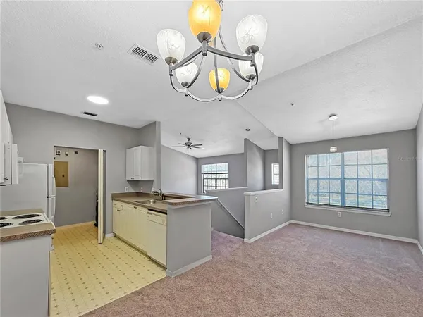 a open kitchen with cabinets and stainless steel appliances