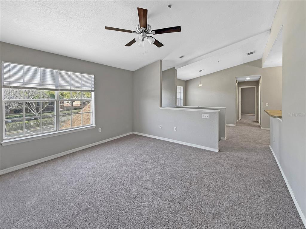 860 Grand Regency Pointe, Unit 200 Altamonte Springs, FL 32714 - Photo 5 of 23 an empty room with fan and windows