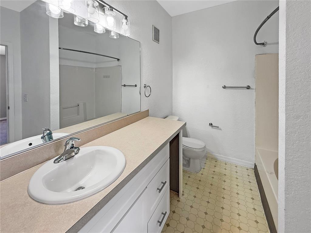 860 Grand Regency Pointe, Unit 200 Altamonte Springs, FL 32714 - Photo 8 of 23 a bathroom with a sink a toilet and shower