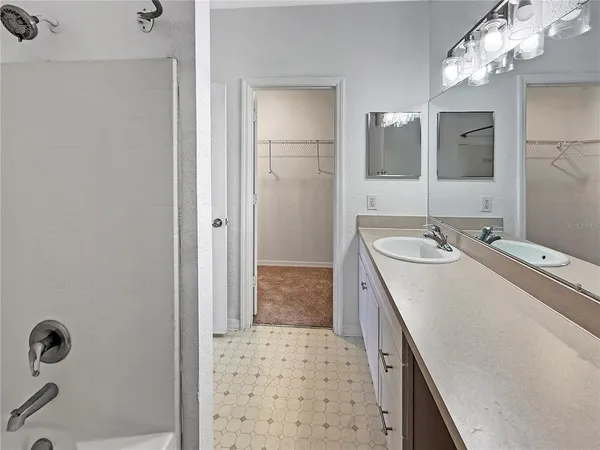 a bathroom with a sink a mirror and a shower
