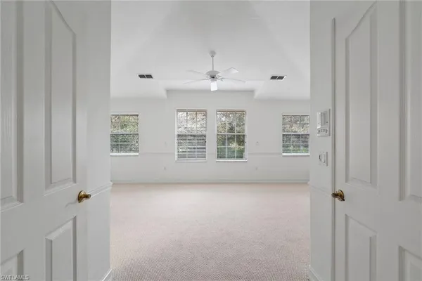 an empty room with a cabinet and a window