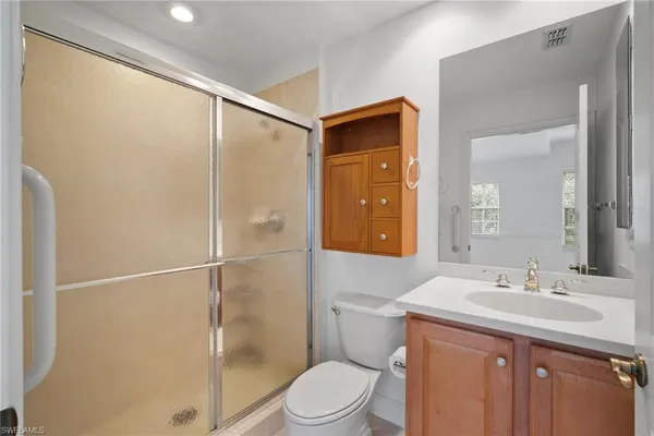 a bathroom with a tub sink shower and mirror