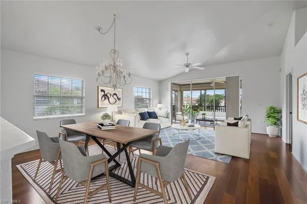 a view of a dining room with furniture wooden floor and chandelier