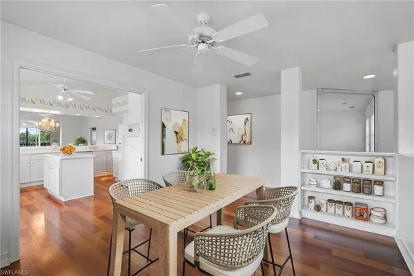 a view of a dining room with furniture and a chandelier