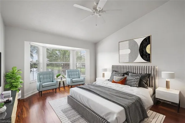 a bedroom with a bed and a large window with outer view